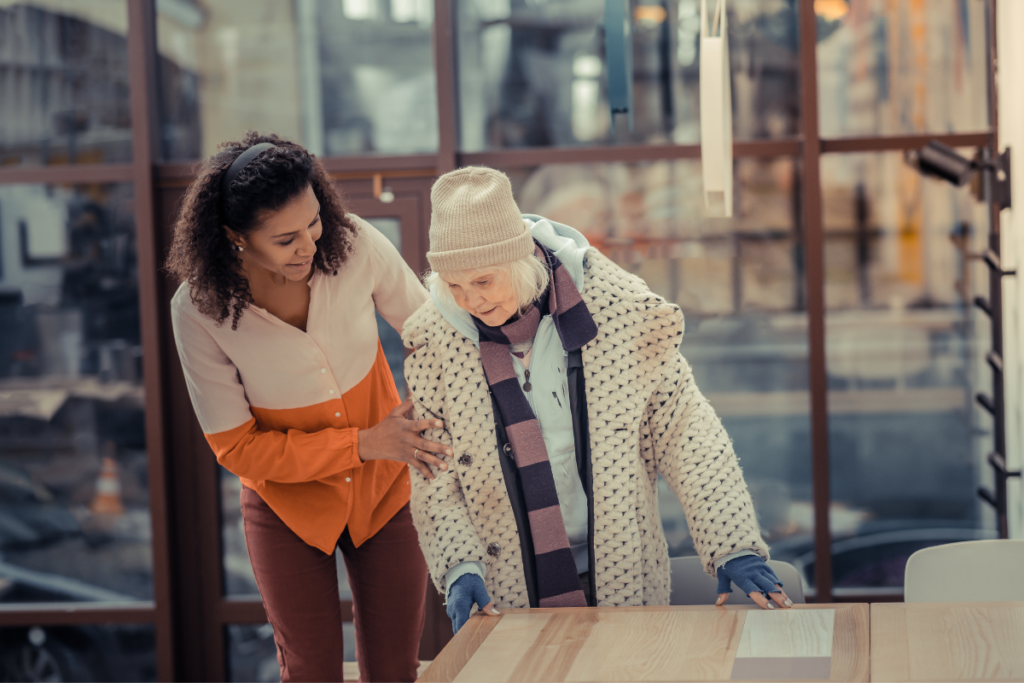Kindness in action: A person assisting an elderly individual