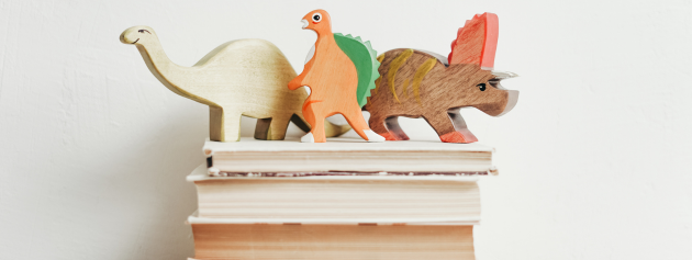 expressive storytelling: animal figures on top of a pile of books