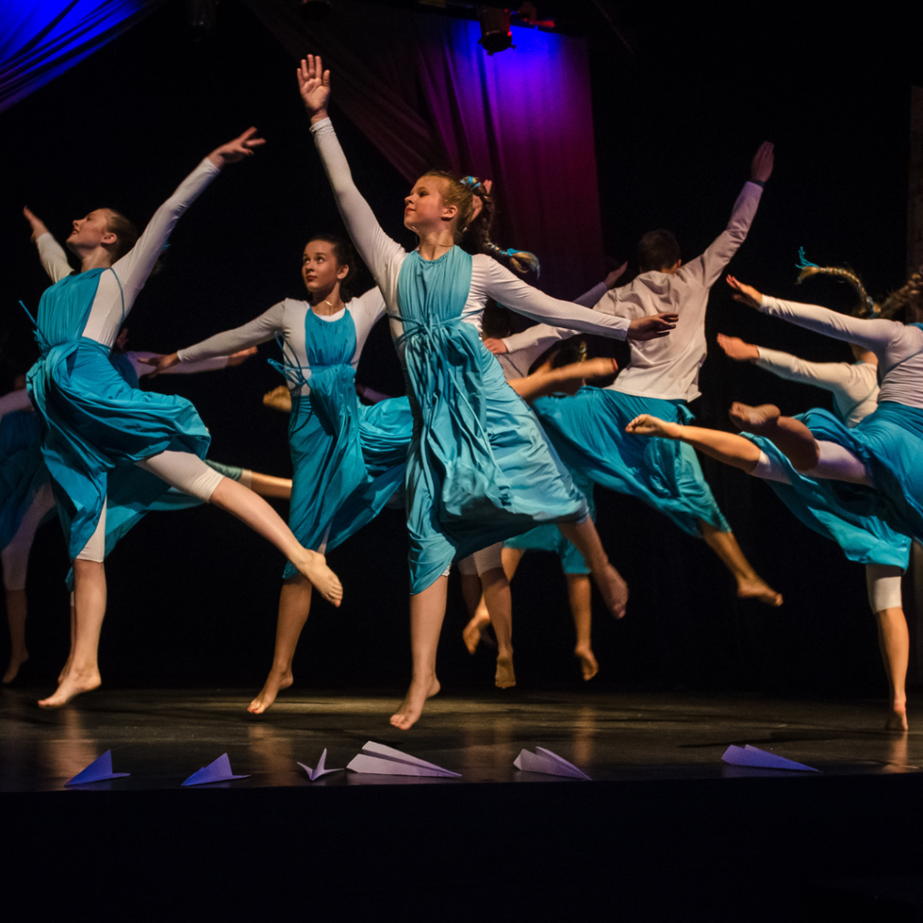 Dancers performing on stage, showcasing artistic endeavours through the beauty and movement of the performing arts.