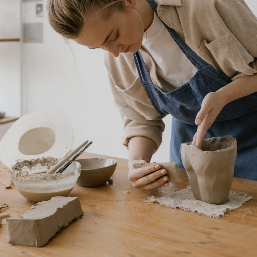 A sculptor's hands shaping clay, illustrating the process of artistic endeavours and creation.