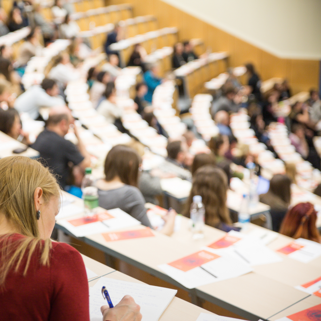 A professor delivering a lecture on the impact of artistic endeavours in academic discourse.