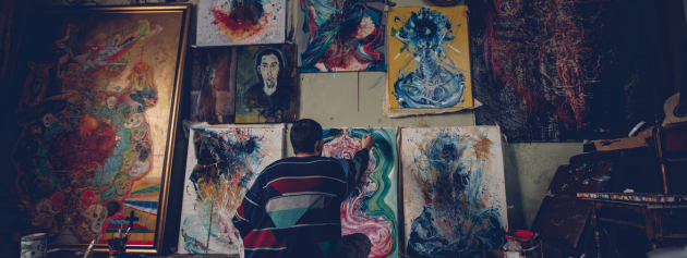Artist working on a vibrant painting, emphasizing artistry in the artistic endeavours.