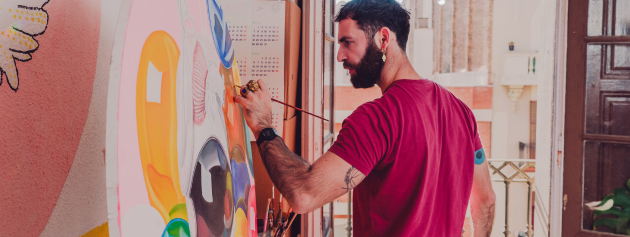 Diverse artist creating a vibrant mural that reflects community values and innovation.