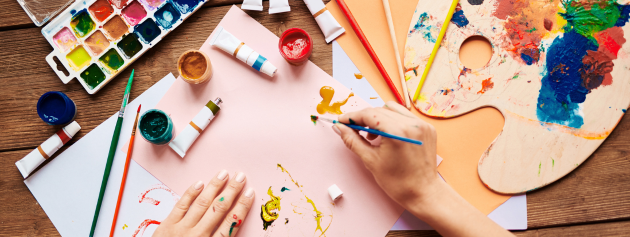 An individual sketching in a notepad during a break at work, illustrating the integration of artistic endeavours into daily life.