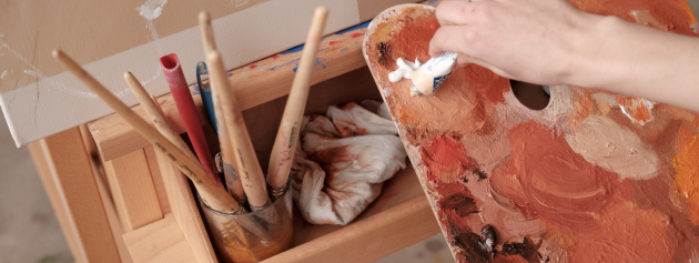 Art supplies in an art workshop, highlighting the educational benefits of artistic engagement.