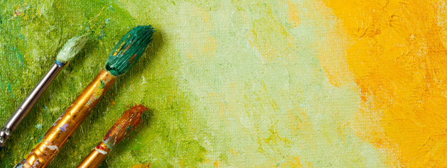 Close-up of paint brushes on a painting, representing the process of personal expression through art.