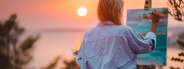 An artist painting outside, illustrating the beauty of the sky as a form of artistic expression.