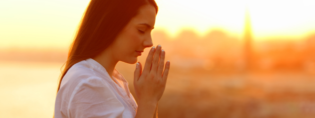 Gratitude stories: A woman in prayer at dusk
