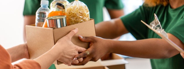 giving back experiences: volunteers giving out food packages