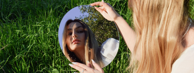 self-discovery: a lady looking at her reflection